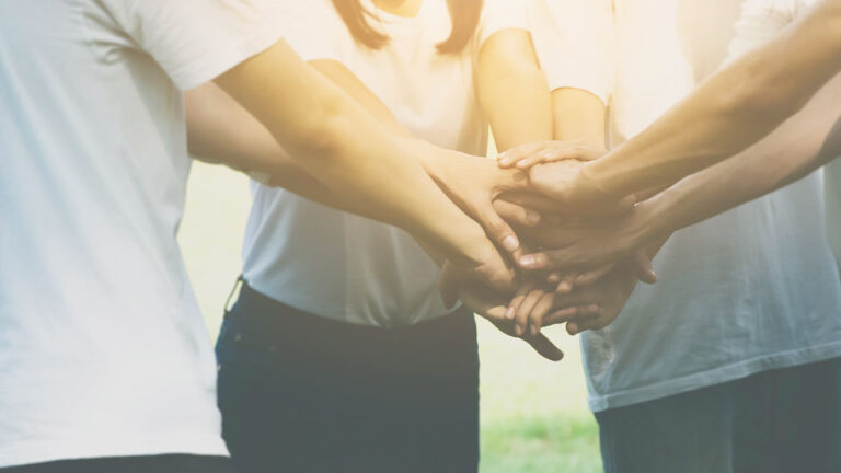 team joining hands